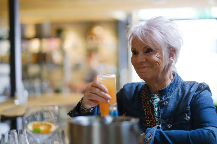 A guest with a gin cocktail in the distillery