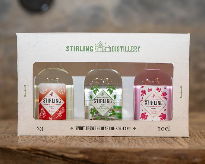 Packaged set of Stirling Distillery bottles on a wooden surface with a blurred background